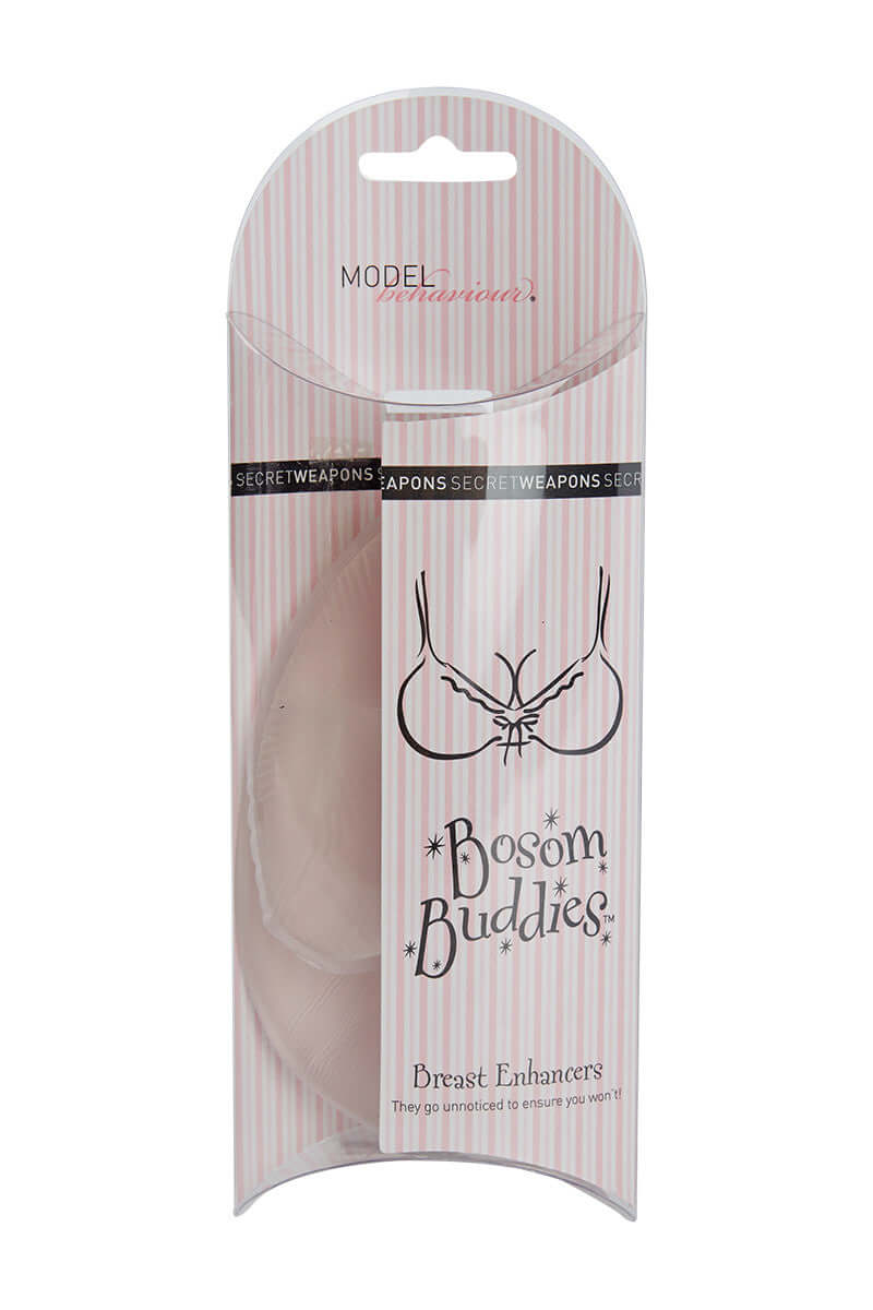 Packaging of "Bosom Buddies" breast enhancers with vertical pink stripes. Text includes "MODEL behaviour," "SECRET WEAPONS," and "They go unnoticed to ensure you won’t!" featuring a simple bra illustration.