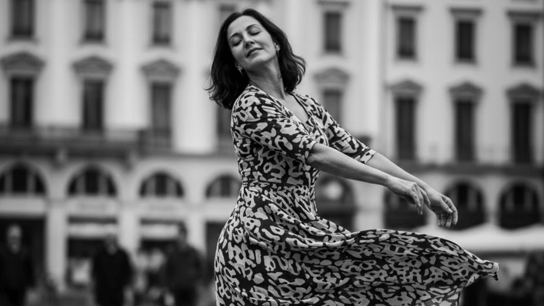 a woman wearing a dress gracefully moving 
