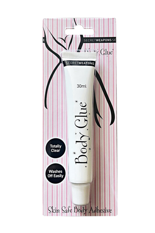 A tube labeled "Body Glue" in sleek packaging, featuring text: "30ml," "Totally Clear," "Washes Off Easily," over a pink and white striped backdrop. Described as "Skin Safe Body Adhesive."