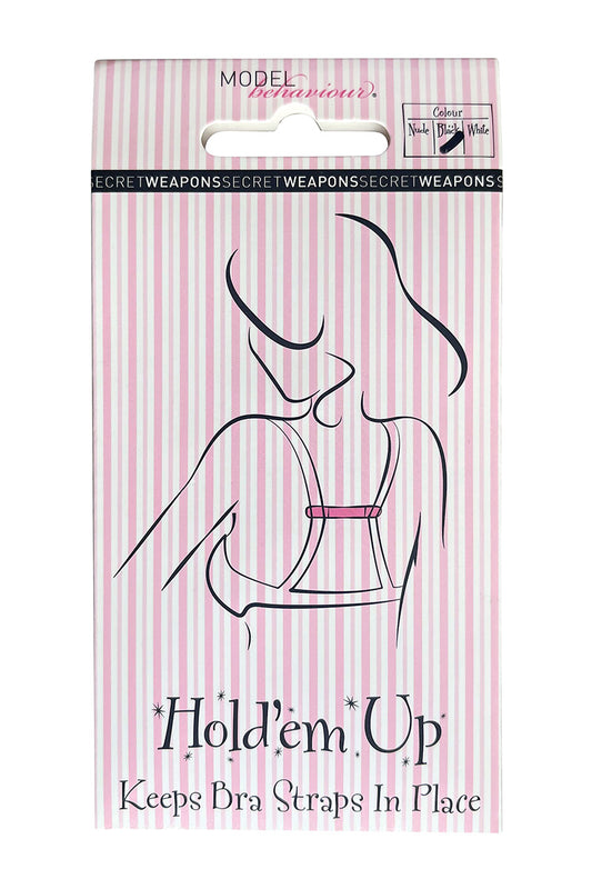 Packaging with pink and white stripes features an illustration of a person wearing a bra. Text reads: "MODEL behaviour," "SECRET WEAPONS," "Hold'em*Up," "Keeps Bra Straps In Place," "Colour," with options "Nude," "Black," "White."