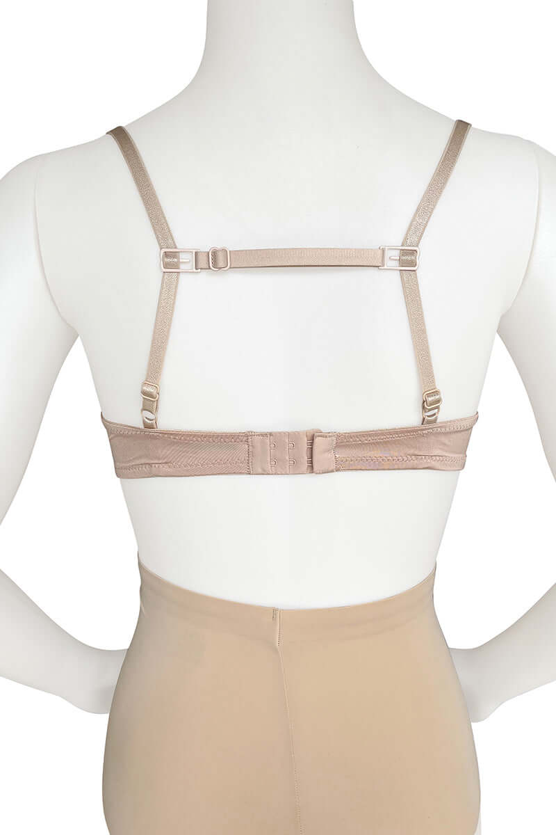 A mannequin displays a beige bra with adjustable straps and back closure, set in a plain studio environment. The bra's texture and fit are clearly visible.