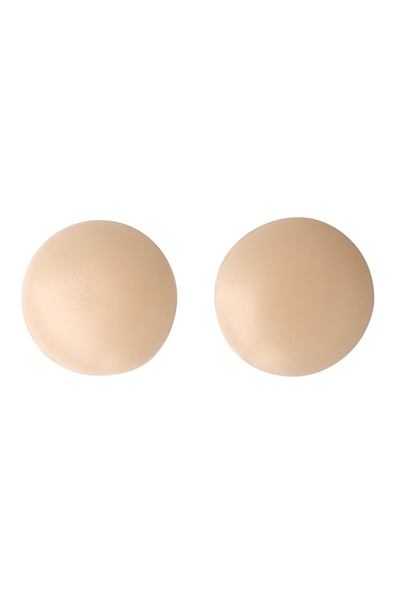 Two beige, round adhesive covers, positioned side by side, against a plain white background.