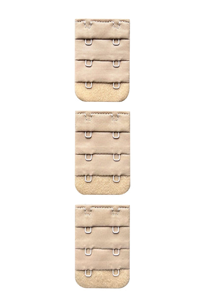 A set of three 2 hook nude/beige skin tone colour bra strap extenders ona white background