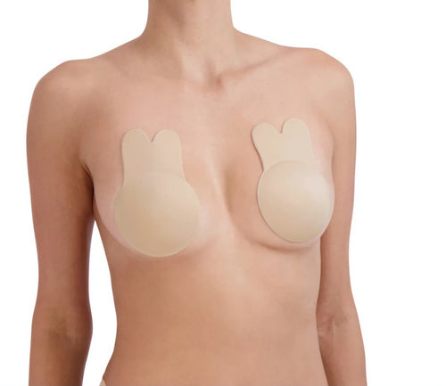 Lady with a light skin tone wearing a rabbit ear bra on a white background