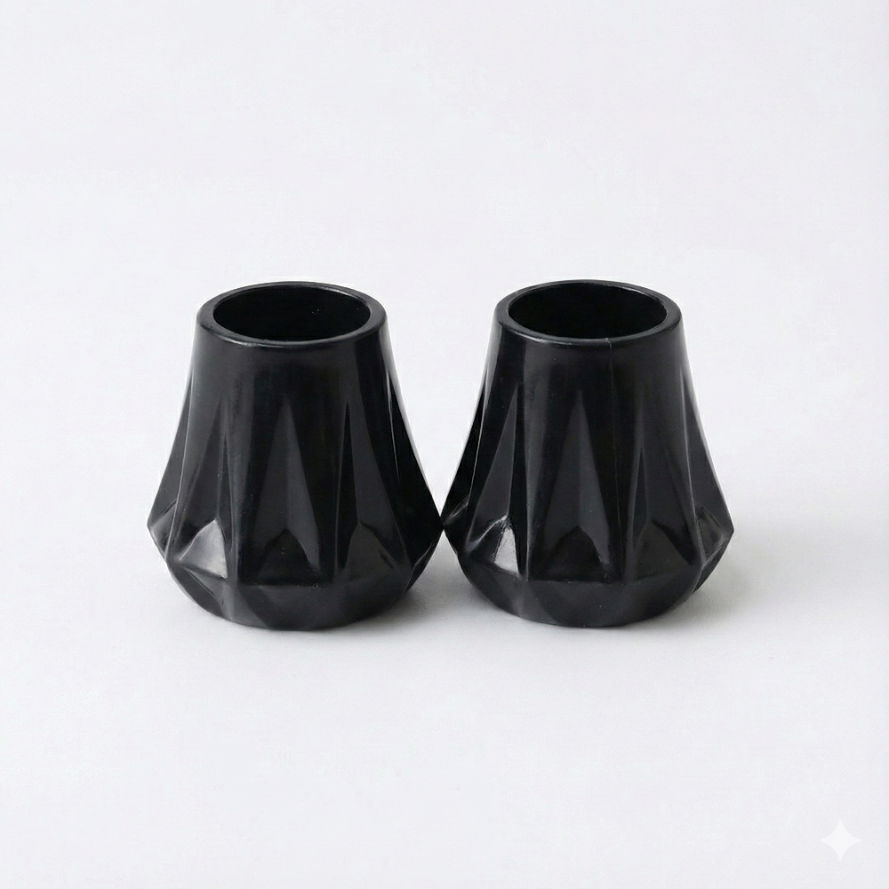 two black heel protectors showing the universal fitting system on a white background