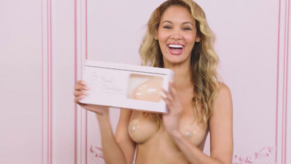 Invisible Bra which is sticky on the inside so it sticks to your boobs. This video shows how to put on the sticky bra, it doesn't have any  straps and is backless. The product is called Nudi Boobies and a women is wearing nipple covers as she demonstrates how to wear the skin coloured bra