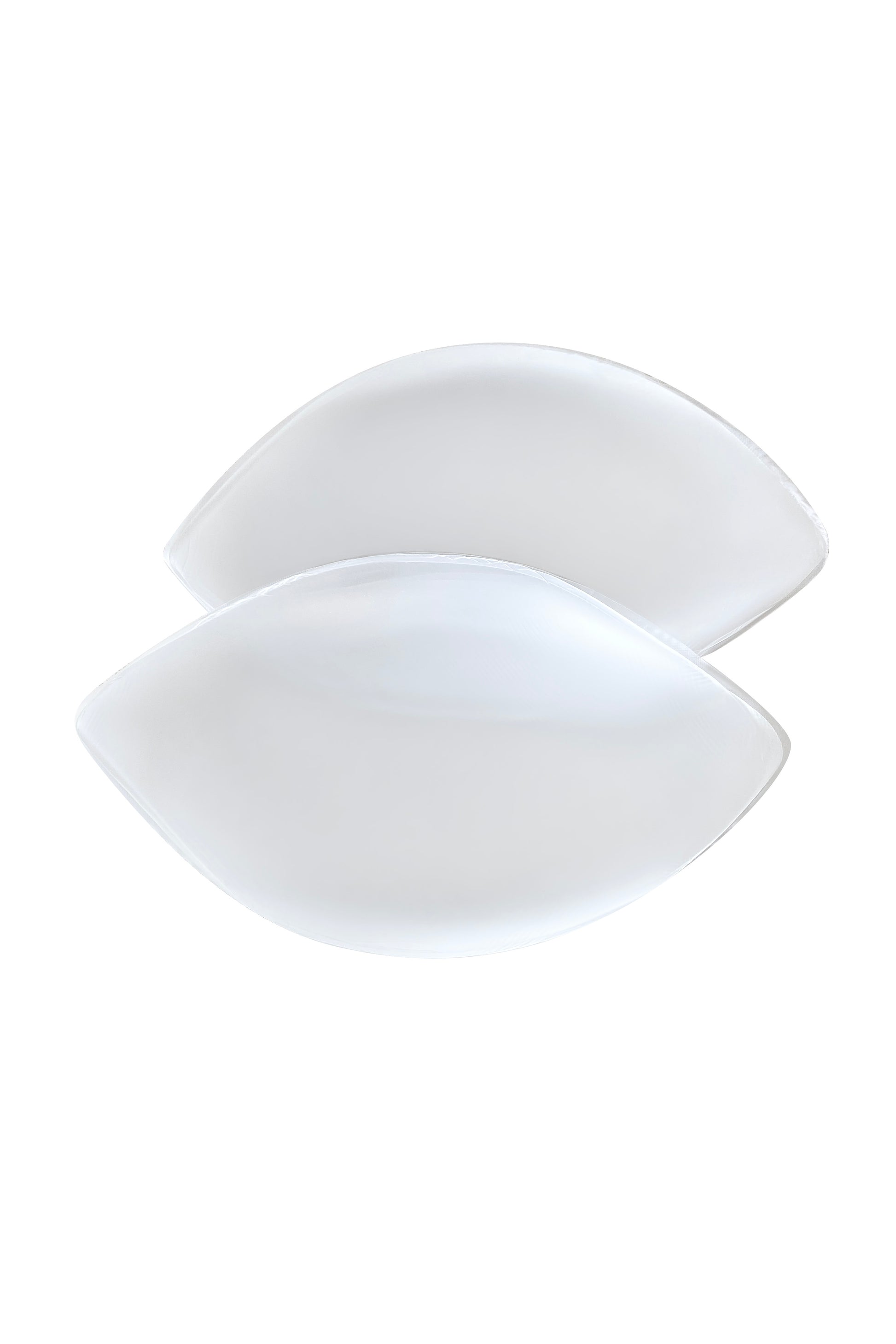 Two overlapping, white, leaf-shaped plates rest against a plain white background, with smooth edges and a glossy finish, creating a minimalist and elegant appearance.