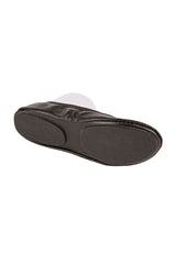 The sole of a pair of black fold up ballet flat shoes against a white background.  