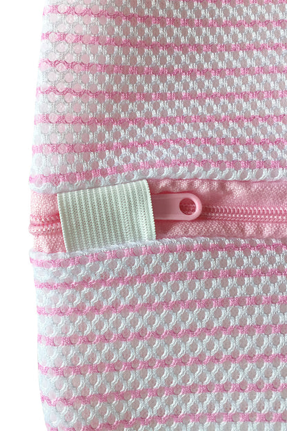 A pink and white textured fabric with a visible zipper partially open, features a small white elastic loop attached, filling the image frame with no surrounding context.