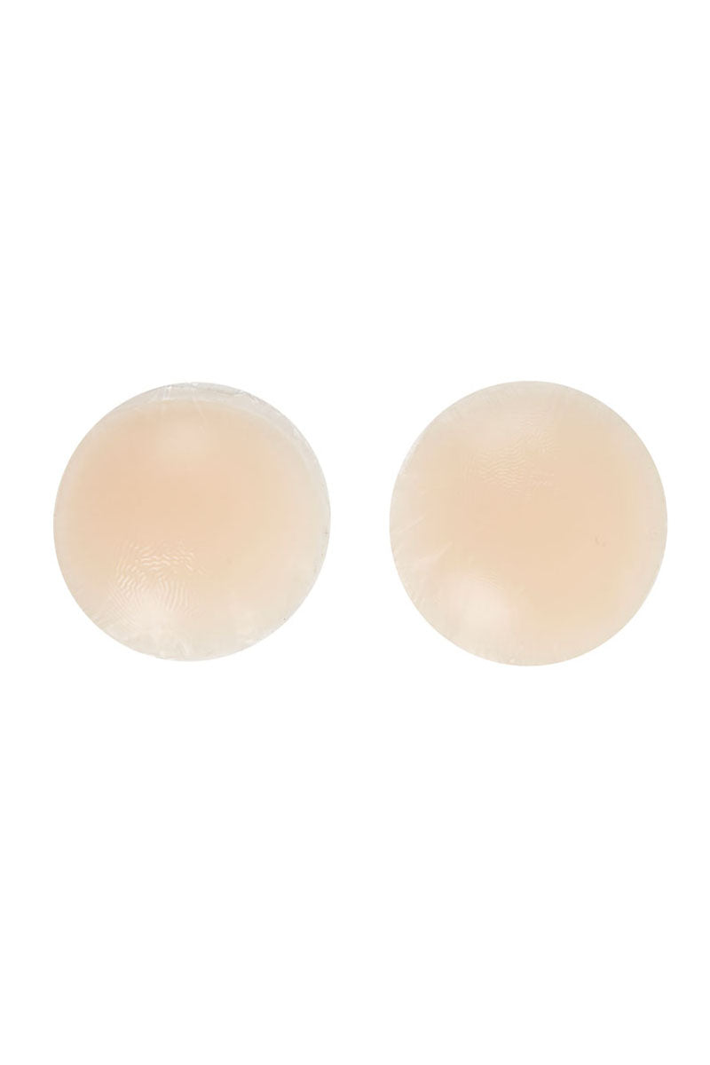 Two circular, beige, smooth-surfaced pads rest side by side on a plain white background, appearing as silicone or fabric coverings.