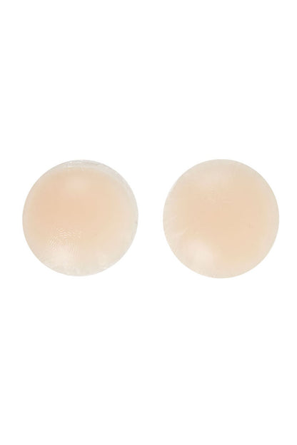 Two circular, beige, smooth-surfaced pads rest side by side on a plain white background, appearing as silicone or fabric coverings.