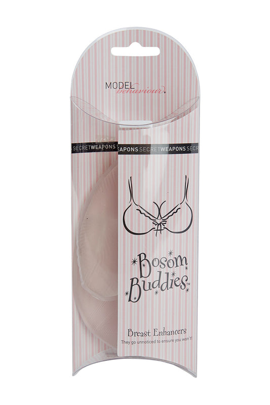 Packaging of "Bosom Buddies" breast enhancers with vertical pink stripes. Text includes "MODEL behaviour," "SECRET WEAPONS," and "They go unnoticed to ensure you won’t!" featuring a simple bra illustration.