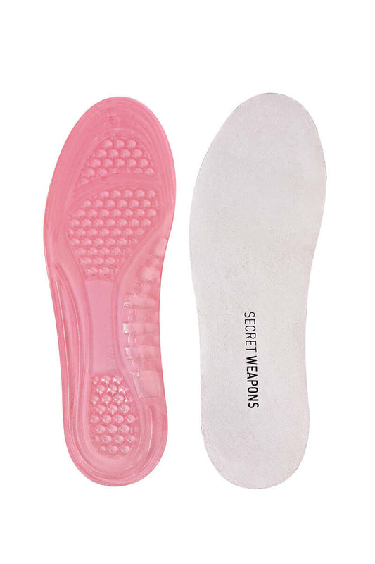 Two shoe insoles displayed side by side; the left is pink with textured grip, the right is white with "SECRET WEAPONS" written on it, against a plain white background.