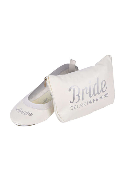A side view of White Bridal Fold Up Ballet Flats and their carry pouch showing BRIDE embellishment