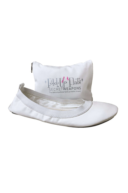 A white Fold Up Ballet Flat and its carry pouch showing the Fold Up Flats lettering on the pouch